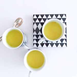 A trio of cups with golden milk.